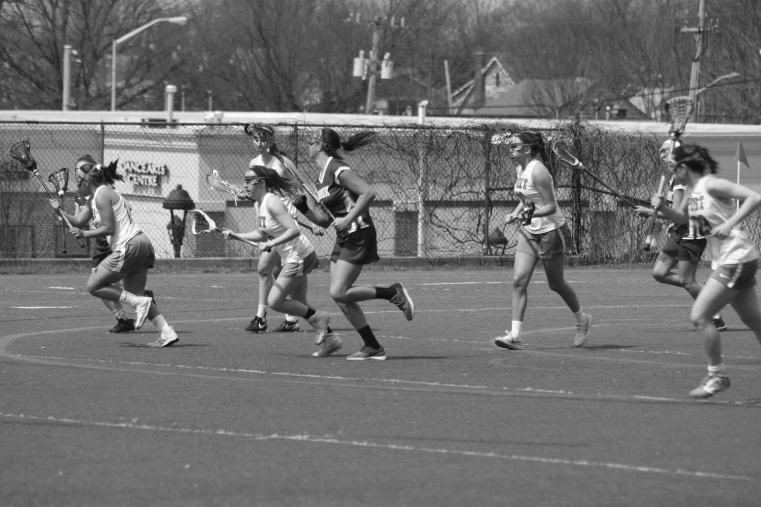 The Vikings girls lacrosse team skirmishes midfield at a home game against Lynbrook on April 10. The Vikings won the game 15-7.