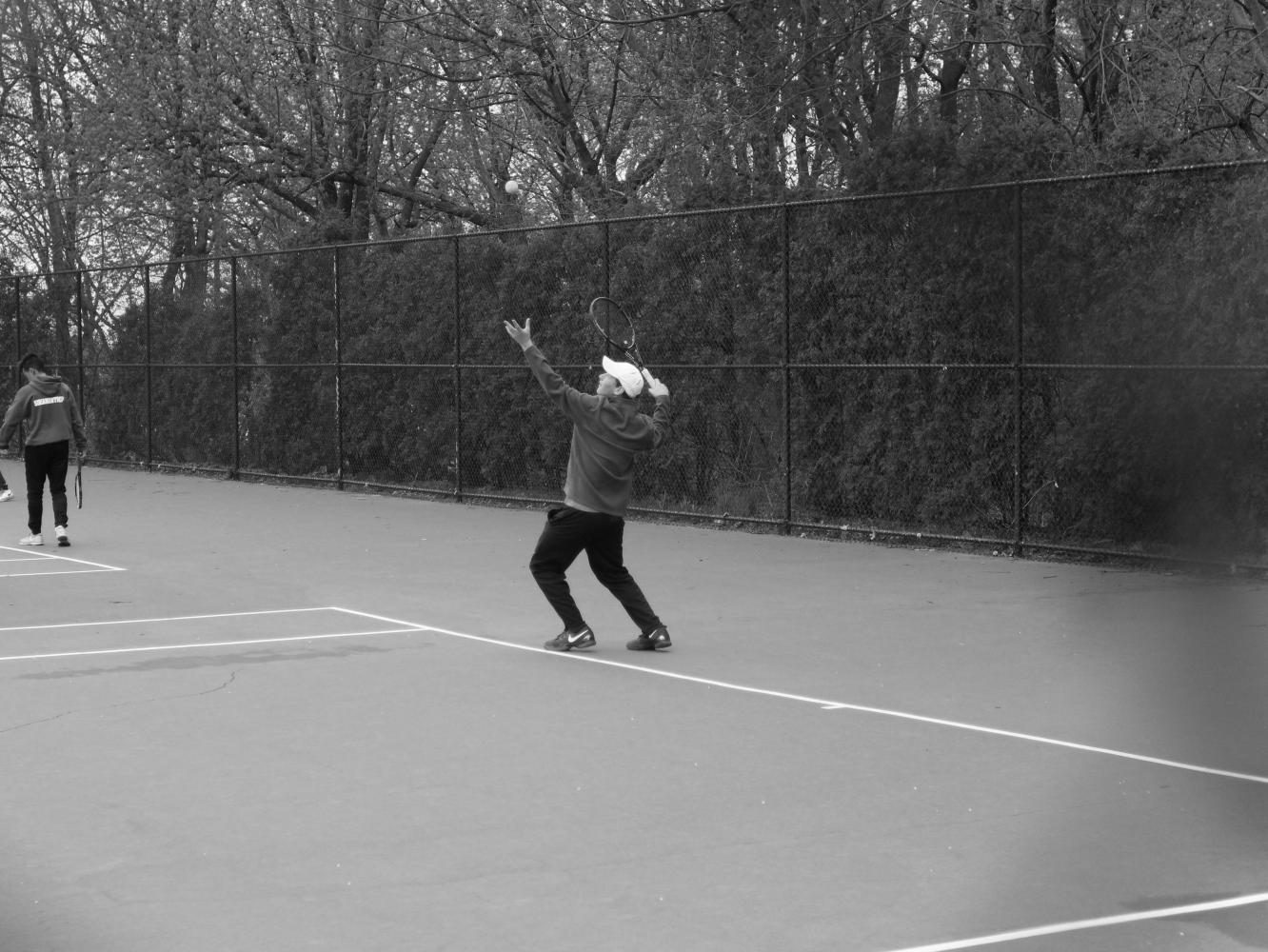 Senior+Austin+Agna+prepares+to+serve+the+ball+against+Cold+Spring+Harbor+at+a+home+match+on+April+5.+The+Vikings+won+the+match+6-1.