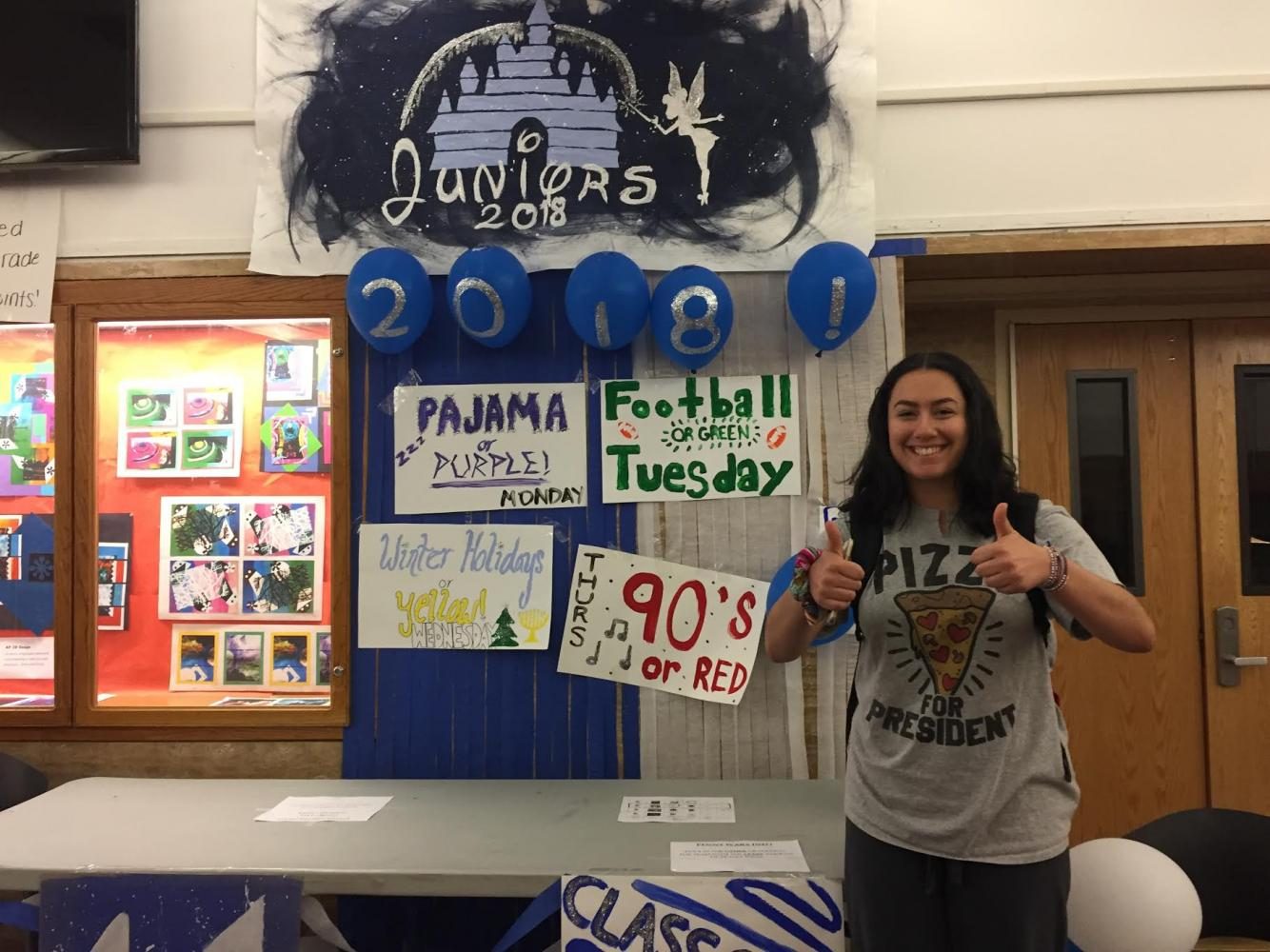 Junior+Lauren+Seltzer+poses+in+front+of+the+junior+table+for+the+first+day+of+Spirit+Week.+On+Monday%2C+students+wore+pajamas+to+school+to+earn+points+for+their+grade.