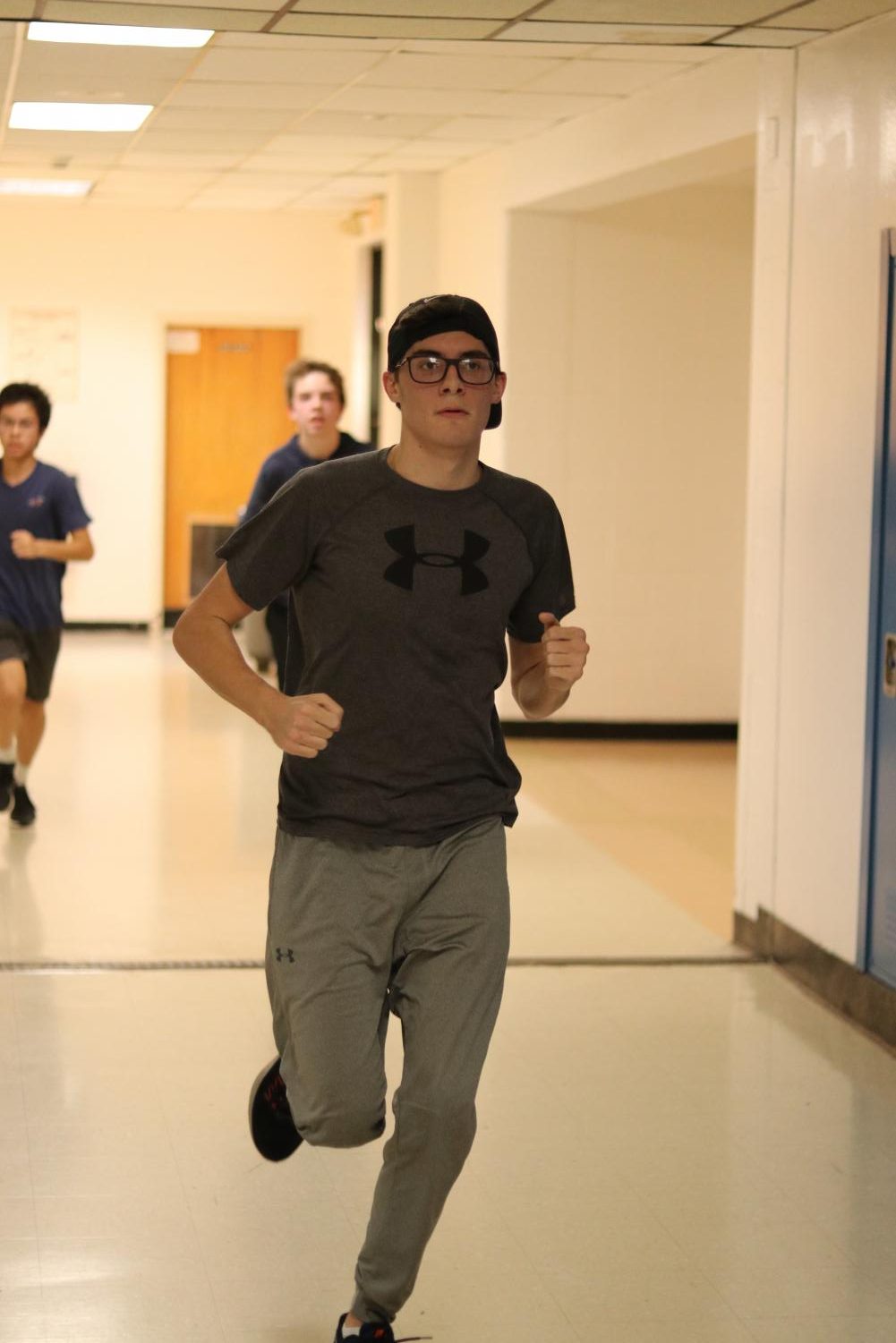 Senior distance runner Patrick Barry runs through the halls during an indoor practice on Dec. 14.