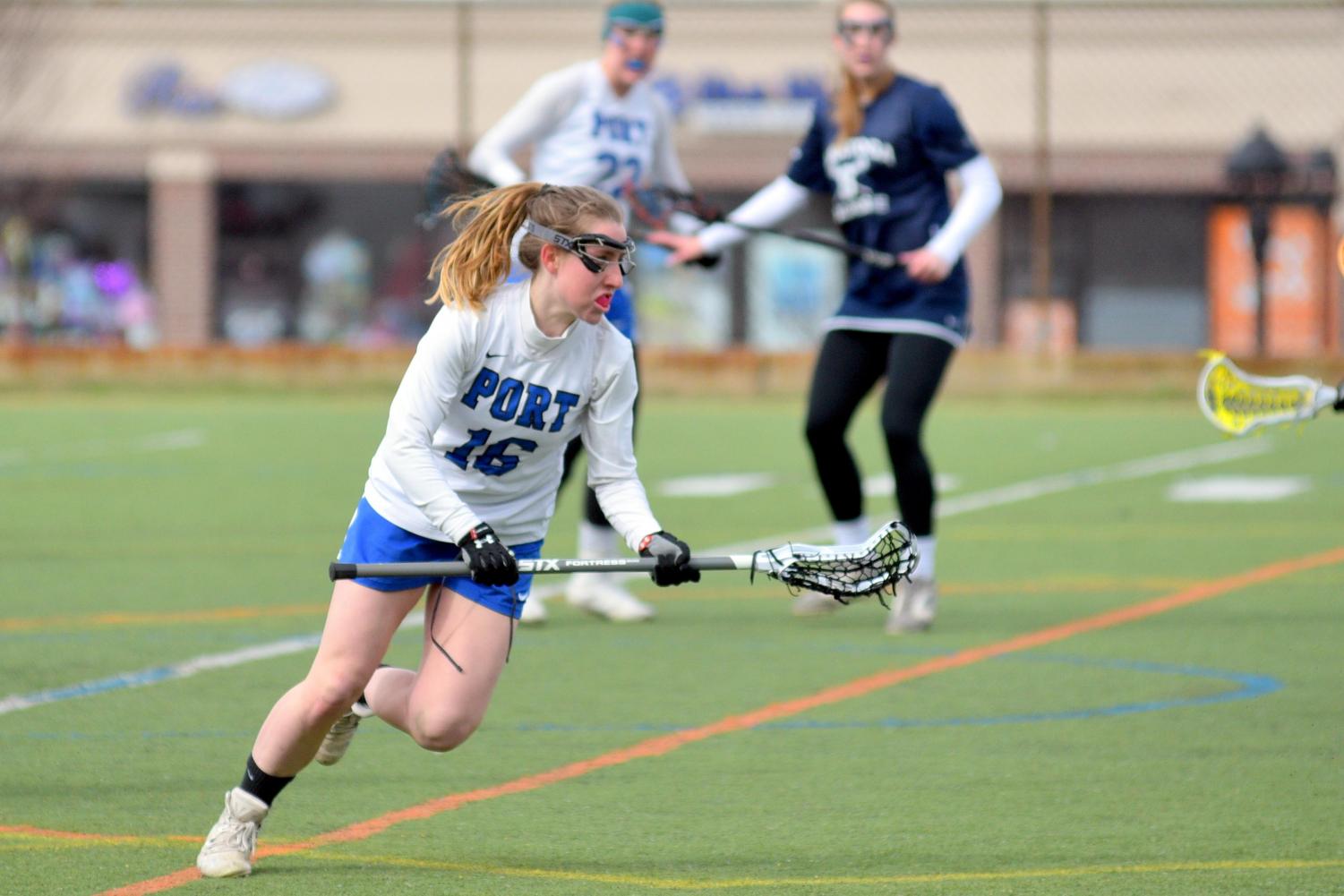 Senior Ali Hoffman looks to advance the ball in a home game against Saratoga Springs on April 7. The Vikings went on to win the game 12-9.