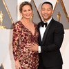 Pop singer John Legend and model Chrissy Teigen greet the cameras on the red carpet at the 2016 Oscars. 