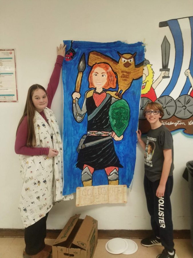 Sophomore Eloise Griffin and freshman Sam Nachimsan showcase their Saturnalia artwork at school event.