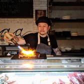 Owner Roy Kurniawan preparing one of his specialty sushi rolls. Innovative cooking techniques like using a blow torch set Tiga apart from other restaurants around Port Washington.