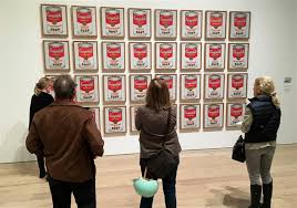 Art lovers bask in the glory of artist Andy Warhols famous Campells Soup Cans at the Museum of Modern Arts Whitney show. According to the New York Times, the exhibit is the largest retrospective of Warhols paintings since 1989.