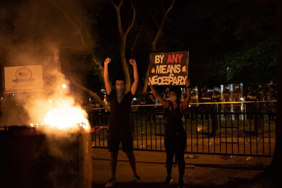 Protestors+stand+in+front+of+a+fire+in+Lafayette+Square%2C+about+a+football+field+away+from+the+White+House.+It+was+in+that+same+square+where+police+fired+tear+gas+at+protestors+to+clear+space+so+that+President+Trump+could+get+a+photo+op+in+front+of+St.+Johns+Episcopal+Church.+